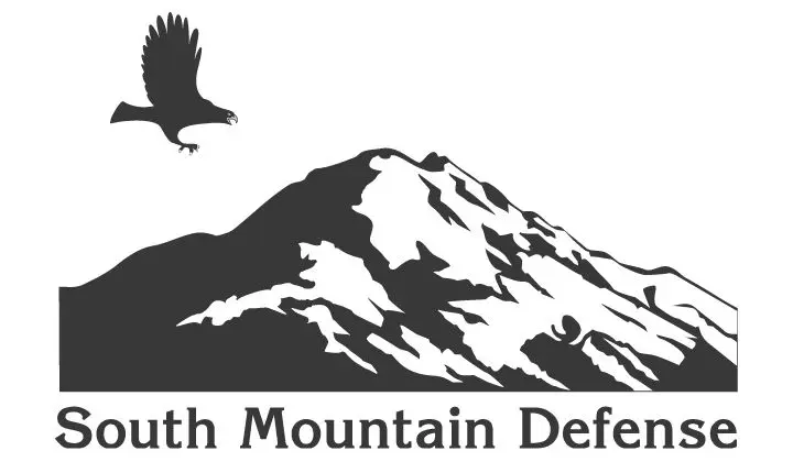 A black and white image of the logo for north mountain defenders.