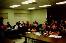 A group of people sitting at tables in a room.