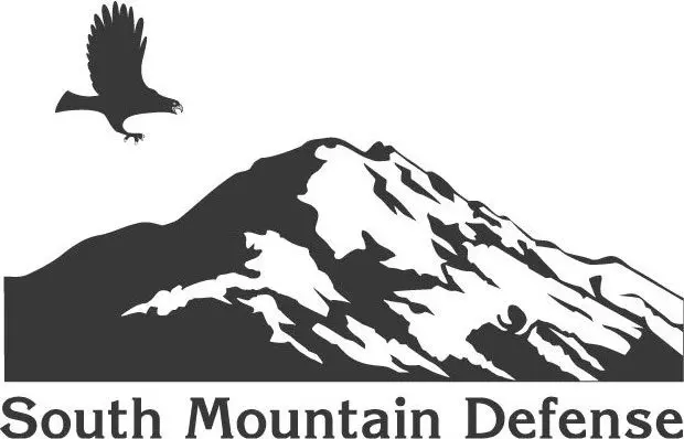 A black and white image of the logo for north mountain defenders.