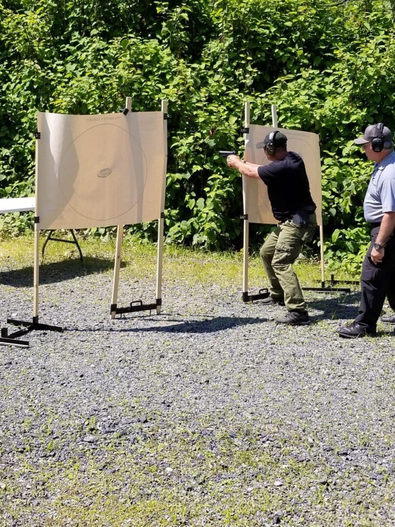 A man is shooting at an event with another person.