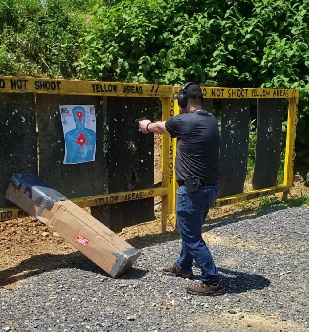 A man is shooting at an outdoor target.
