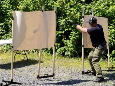 A man is aiming at an object in the air.